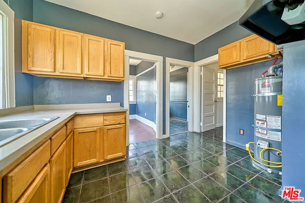 a kitchen with stainless steel appliances granite countertop a sink and a refrigerator