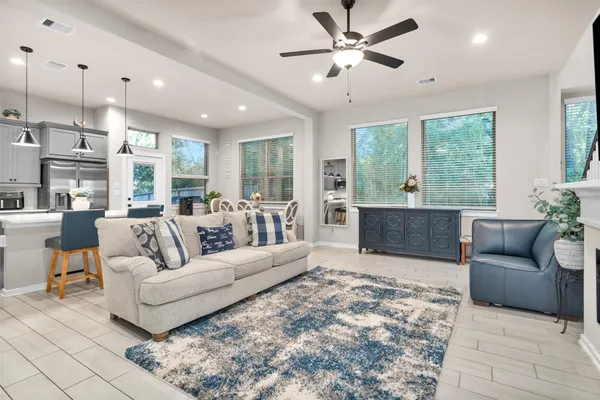a living room with furniture flat screen tv and a fireplace