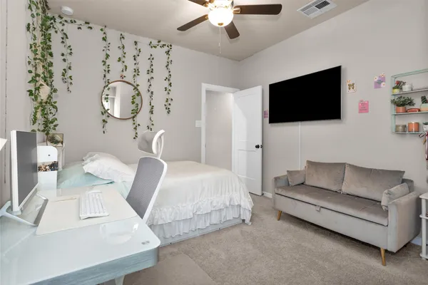 a bedroom with a bed and a couch