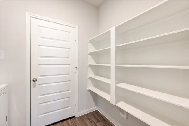a view of walk in closet with empty racks