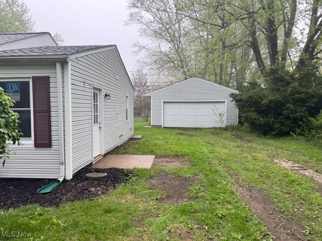 1893 Benjamin Road Madison, OH 44057 - Photo 22 of 23 View of green lawn featuring an outdoor structure and a detached garage