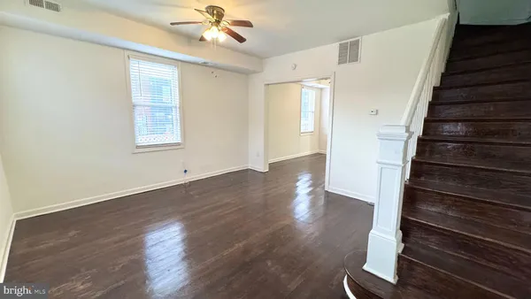 wooden floor in an empty room with a window