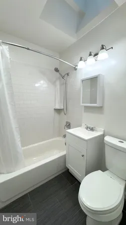 a bathroom with a sink a toilet and bathtub