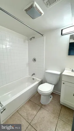 a bathroom with a toilet a sink and bathtub