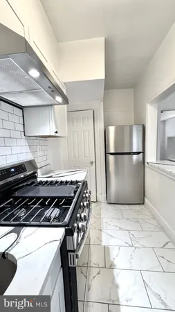 a kitchen with a stove a refrigerator and a cabinets
