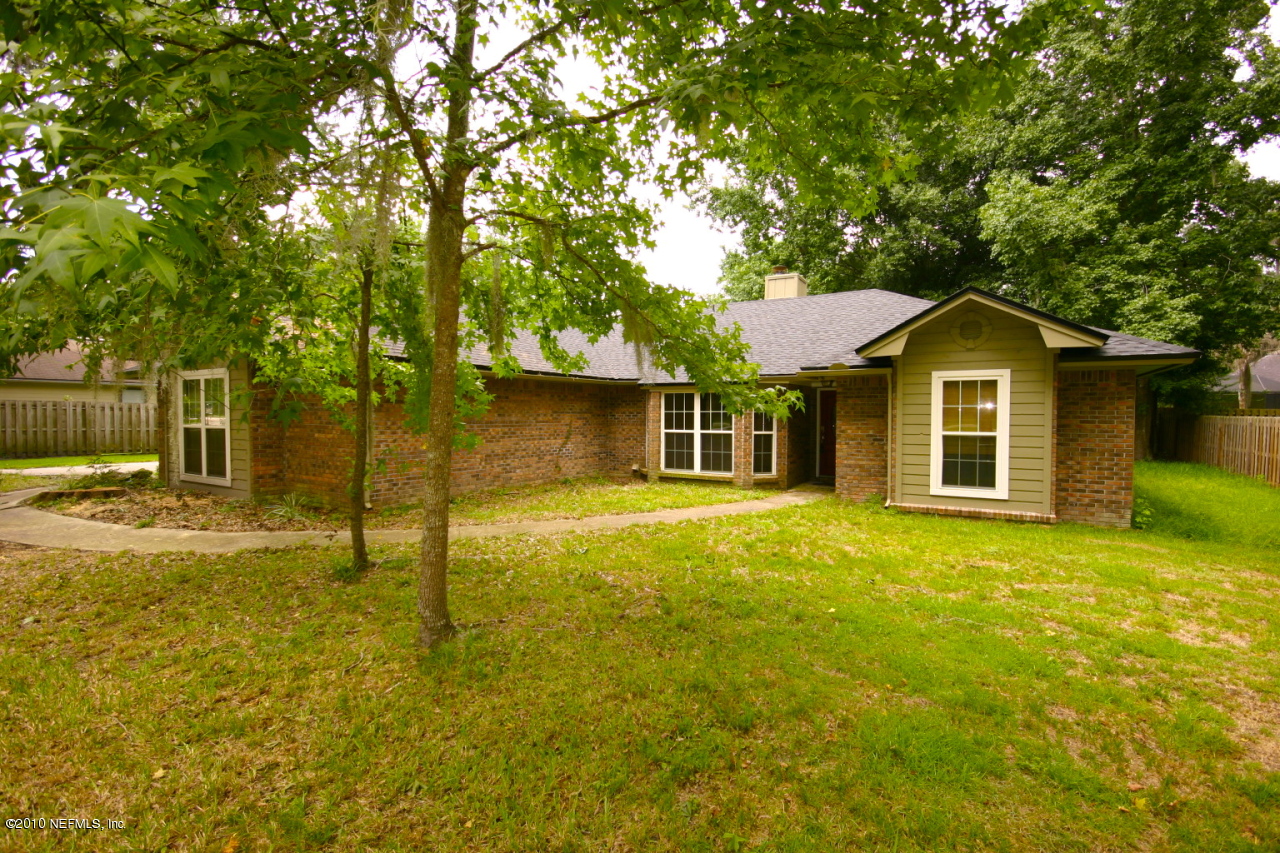 3125 Nautilus Road Middleburg, FL 32068 - Photo 1 of 23 a front view of a house with a yard