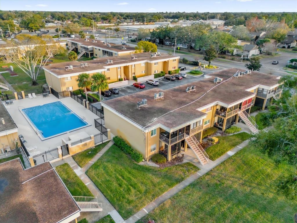 1000 Lake Of The Woods Boulevard, Unit 203E Casselberry, FL 32730 - Photo 1 of 1 an aerial view of a house with a yard swimming pool and outdoor seating