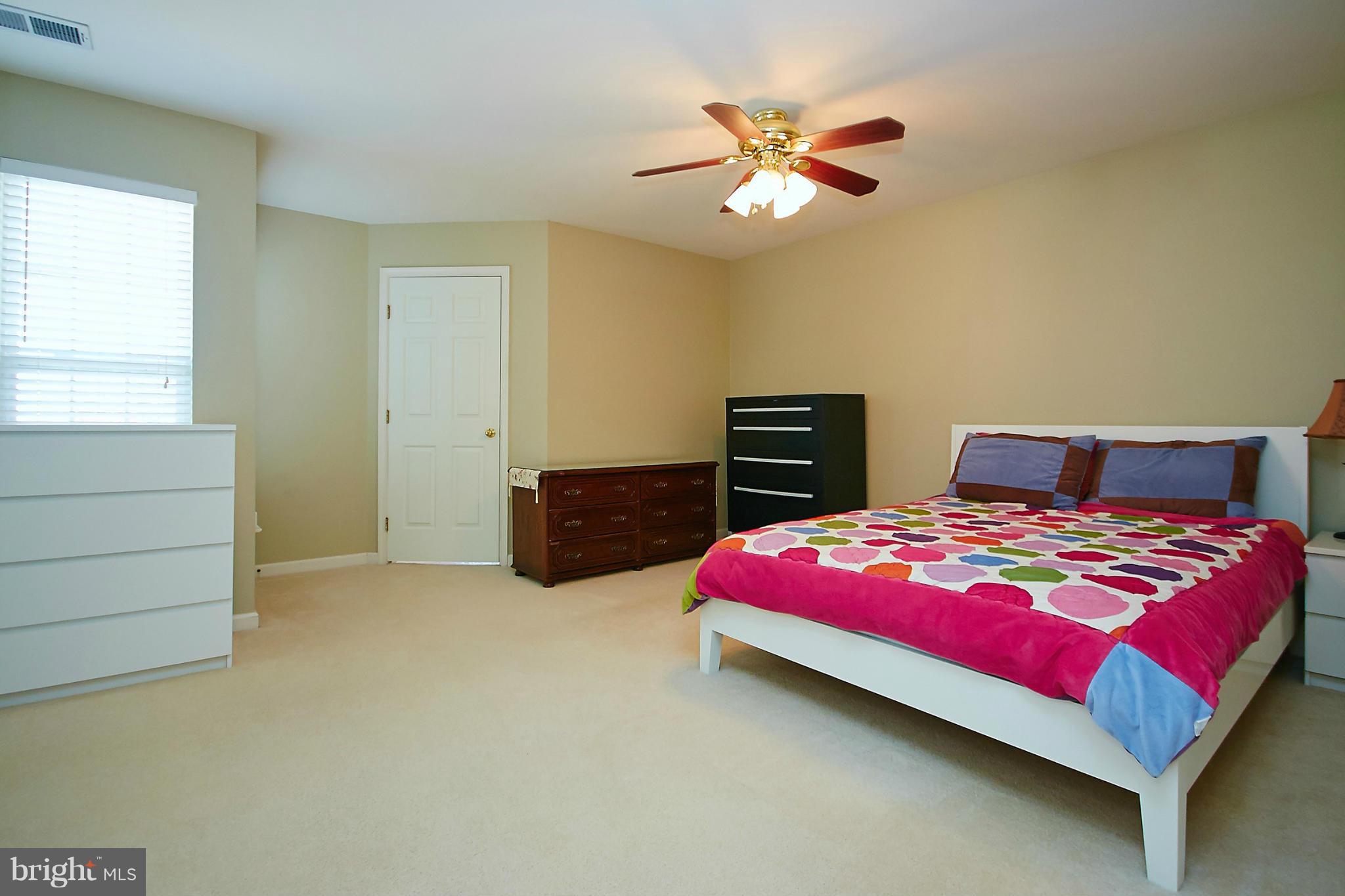 9639 Innerwick Place Bristow, VA 20136 - Photo 14 of 29 a bedroom with a bed and window