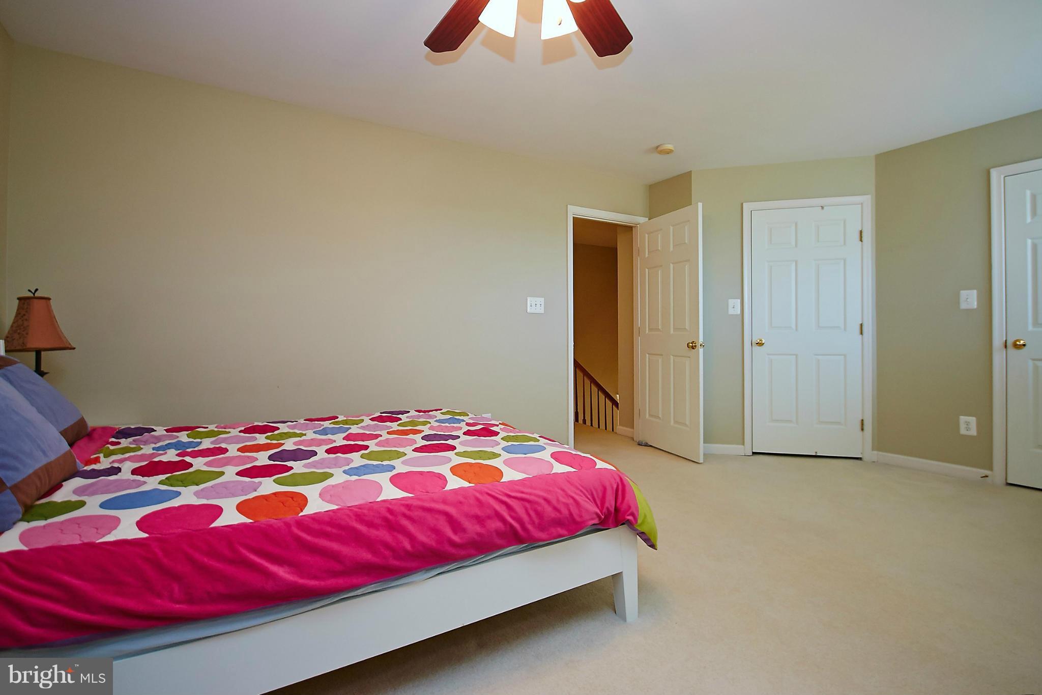 9639 Innerwick Place Bristow, VA 20136 - Photo 15 of 29 a bedroom with a bed and a chandelier