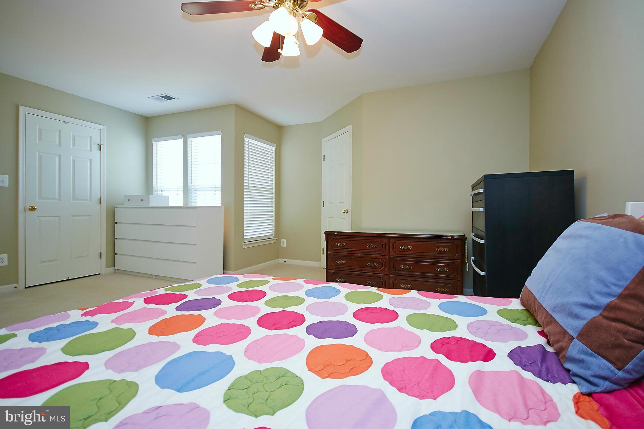 9639 Innerwick Place Bristow, VA 20136 - Photo 16 of 29 a bedroom with a bed and a lamp on dresser
