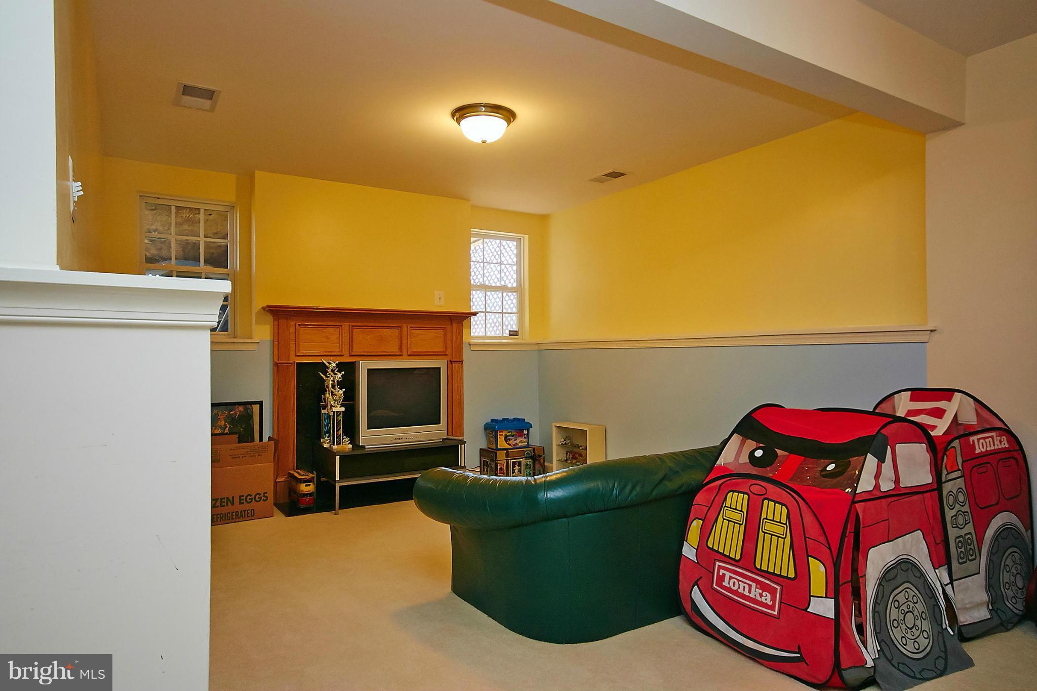 9639 Innerwick Place Bristow, VA 20136 - Photo 24 of 29 a bedroom with a bed and a car parked in it