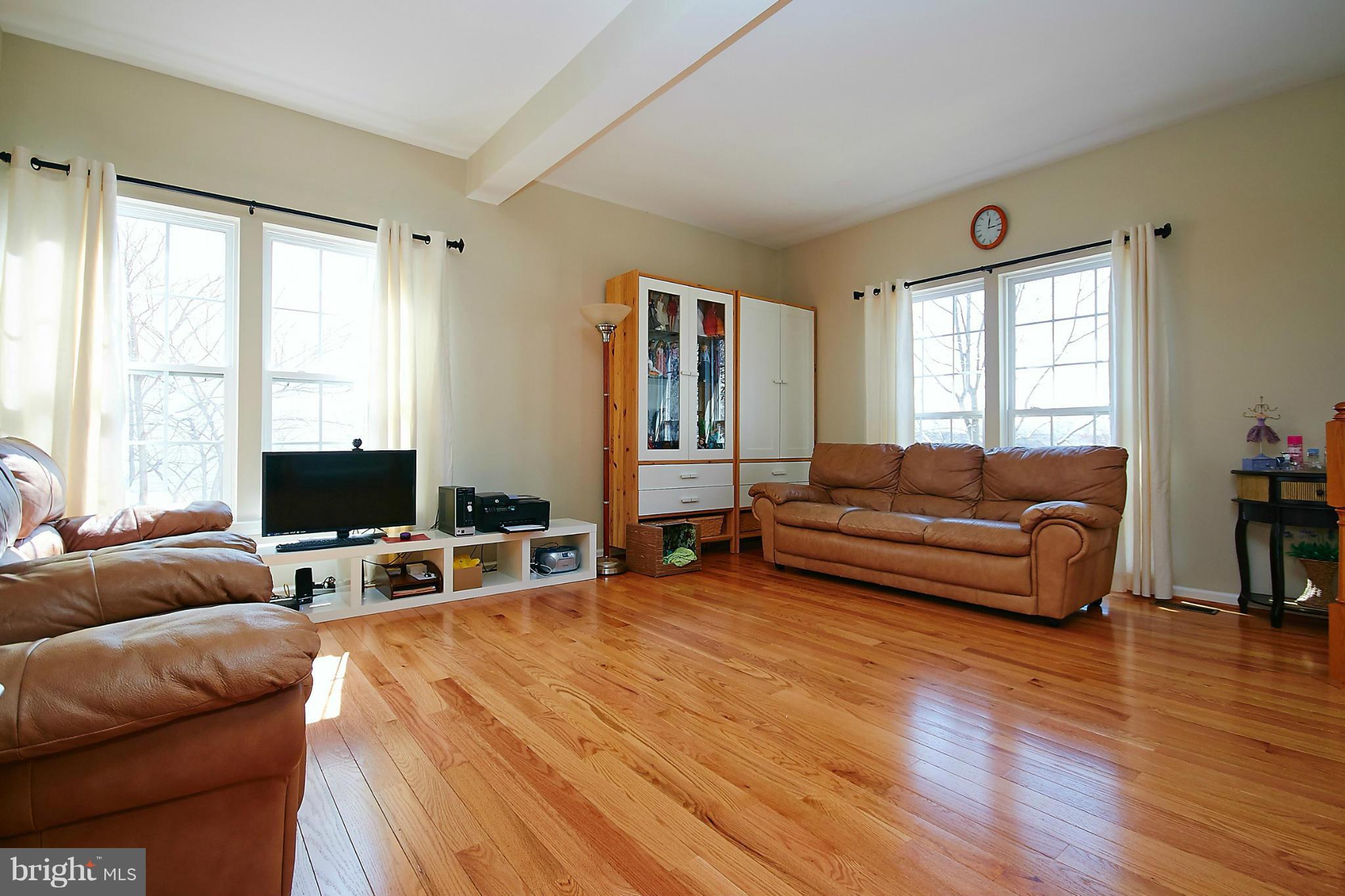 9639 Innerwick Place Bristow, VA 20136 - Photo 5 of 29 a living room with furniture and a flat screen tv
