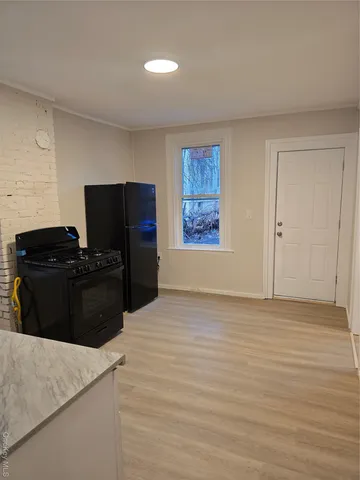 a kitchen with a refrigerator and a stove