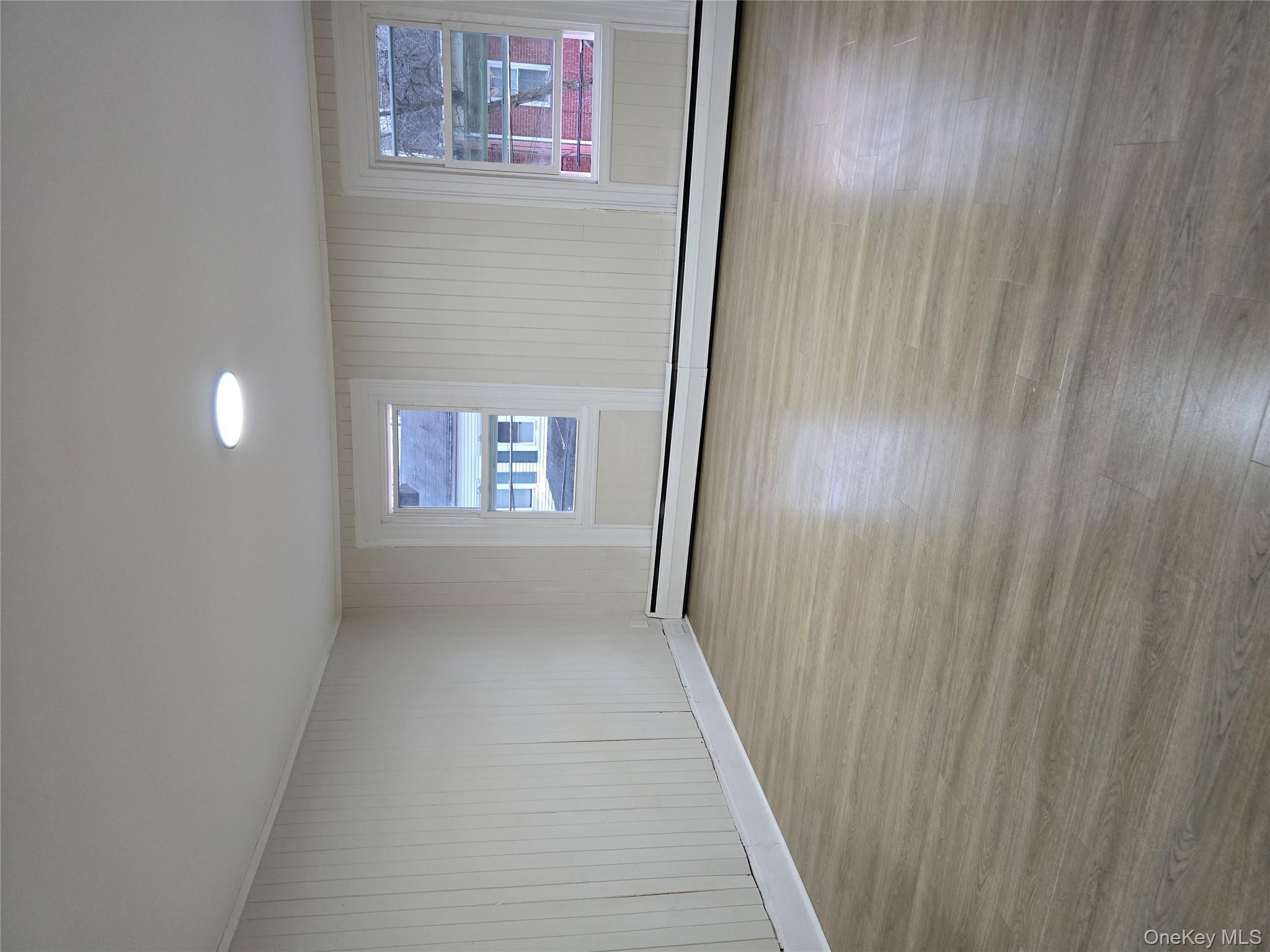 185 Mill Street Poughkeepsie, NY 12601 - Photo 16 of 26 a view of an empty room with wooden floor