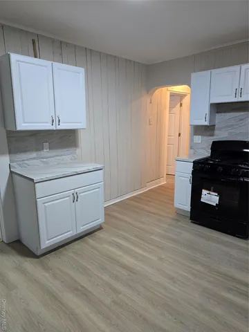 a kitchen with granite countertop a stove a sink and a granite counter tops