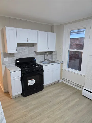 a kitchen with a sink cabinets and stainless steel appliances