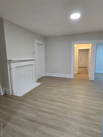 a view of an empty room and wooden floor