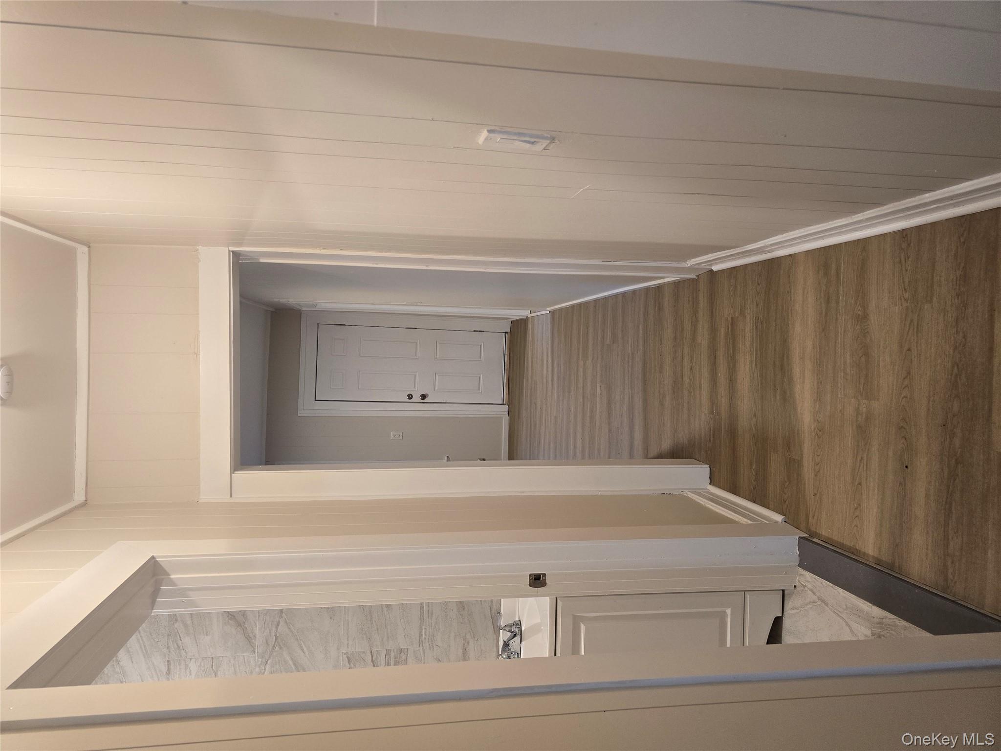 185 Mill Street Poughkeepsie, NY 12601 - Photo 9 of 26 a view of a hallway with wooden floor and staircase