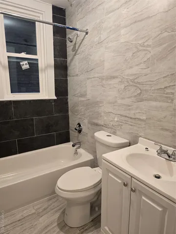 a bathroom with a toilet a sink and bathtub