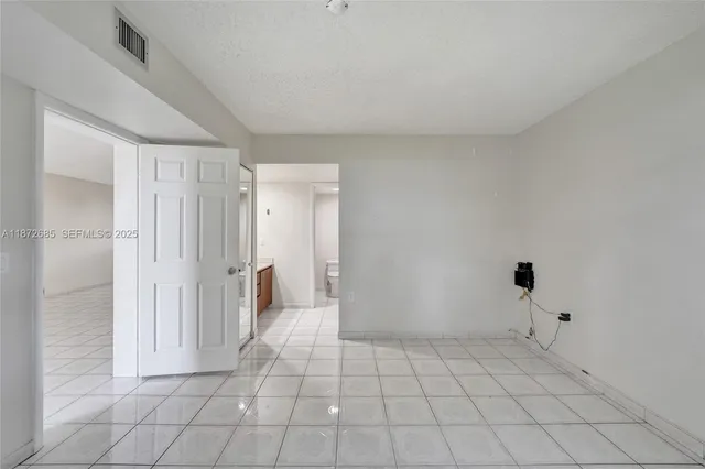 a bathroom with a granite countertop sink a toilet and bathtub