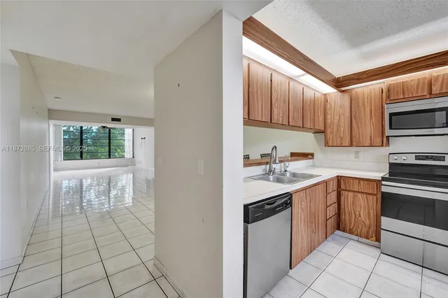 a kitchen with a sink appliances and cabinets