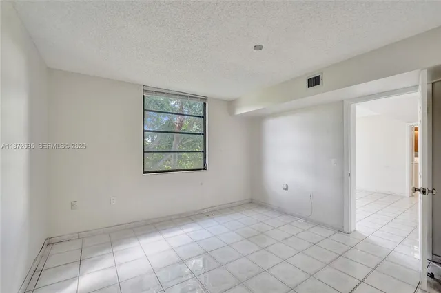 a view of an empty room and a window