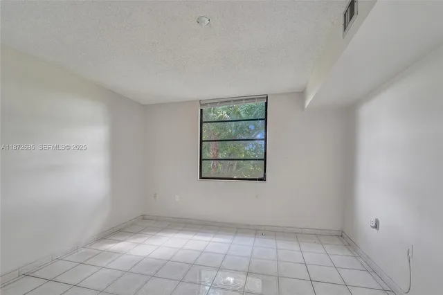 a spacious bathroom with a granite countertop sink a toilet and a large mirror
