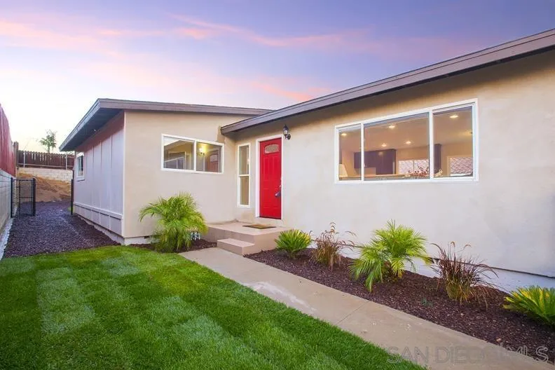 a front view of house with yard and outdoor seating