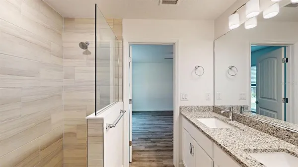 a bathroom with a granite countertop sink and a mirror