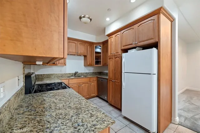 a kitchen with a refrigerator and a stove