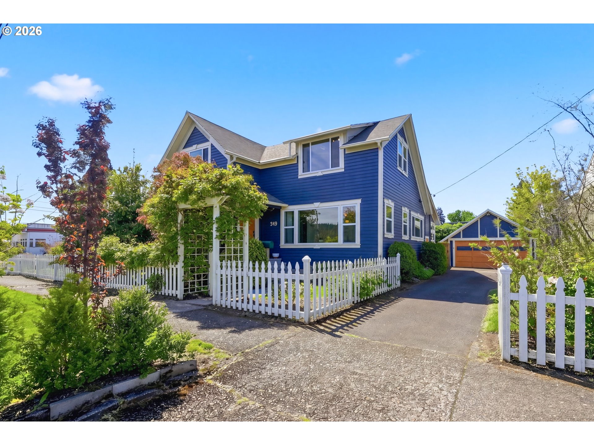 349 South 6th Street Cottage Grove, OR 97424 - Photo 2 of 28 a front view of a house with garden and deck