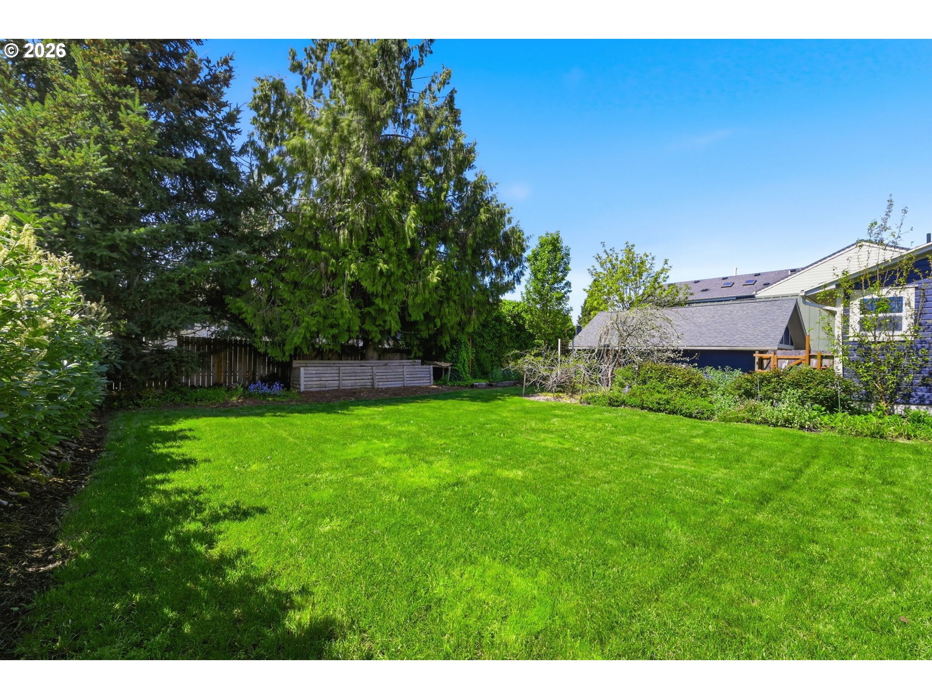 349 South 6th Street Cottage Grove, OR 97424 - Photo 24 of 28 a view of a garden with a building in the background
