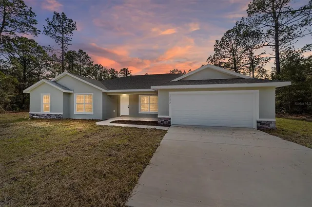 a view of a house with a yard and garage