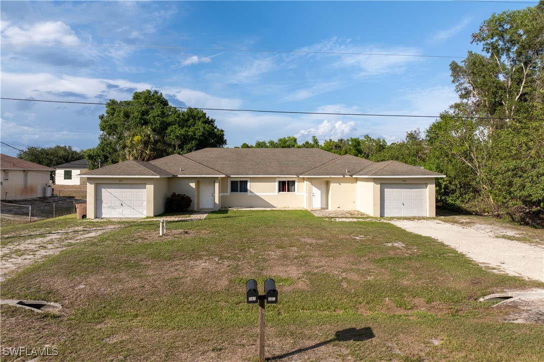 209 Meadow Road Lehigh Acres, FL 33973 - Photo 1 of 48 a view of a house with a outdoor space