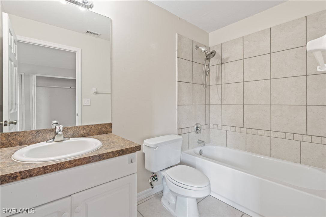209 Meadow Road Lehigh Acres, FL 33973 - Photo 13 of 48 a bathroom with a sink toilet and shower
