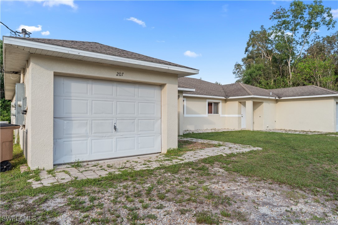 209 Meadow Road Lehigh Acres, FL 33973 - Photo 20 of 48 a backyard of a house