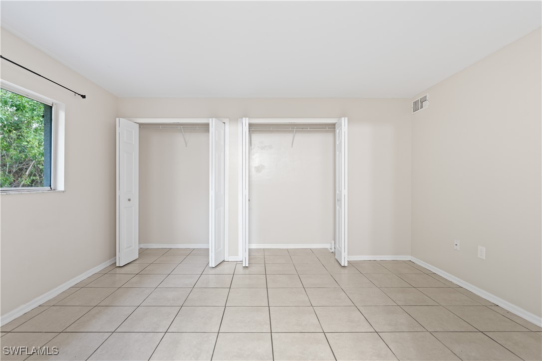209 Meadow Road Lehigh Acres, FL 33973 - Photo 26 of 48 a view of an empty room and window in a room
