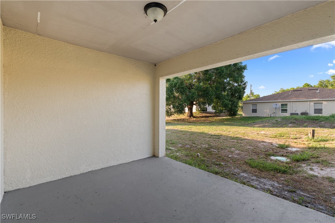 209 Meadow Road Lehigh Acres, FL 33973 - Photo 39 of 48 a view of a living room and floor to ceiling window