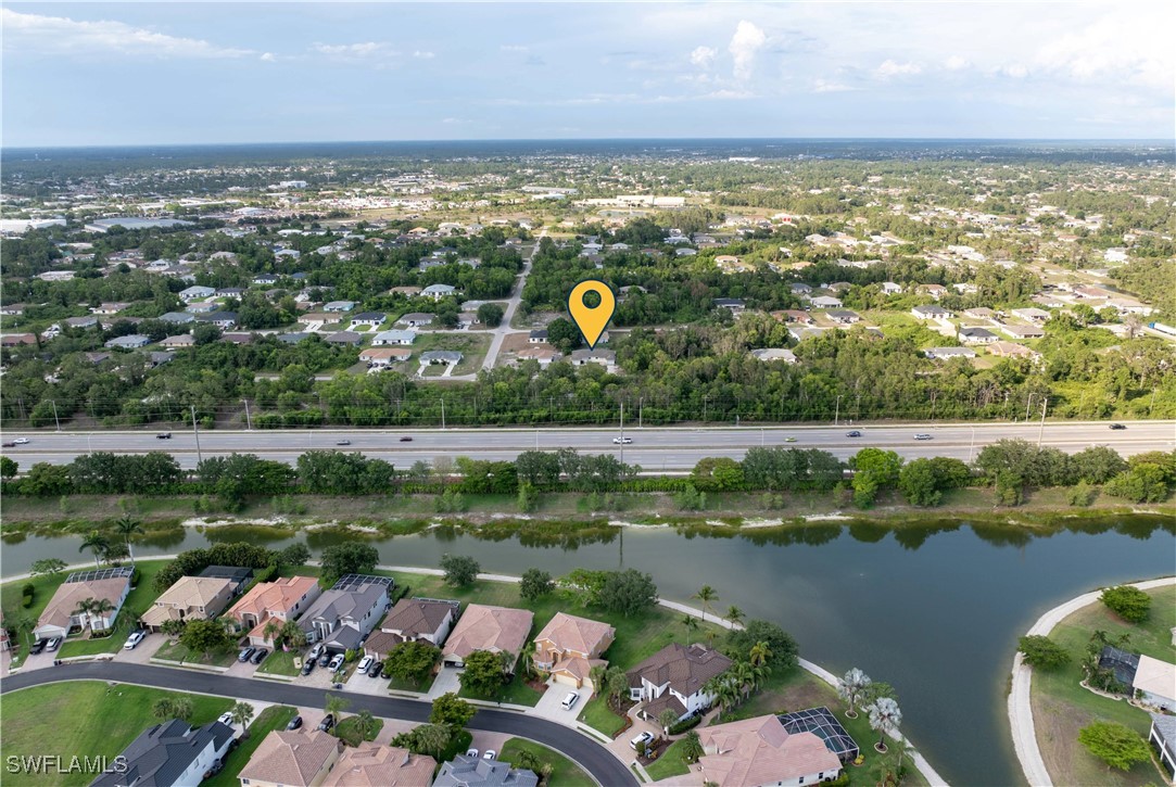 209 Meadow Road Lehigh Acres, FL 33973 - Photo 41 of 48 an aerial view of lake residential house with outdoor space