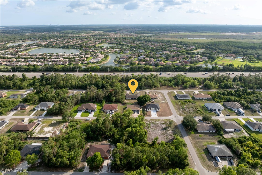 209 Meadow Road Lehigh Acres, FL 33973 - Photo 42 of 48 an aerial view of a city with lots of residential buildings
