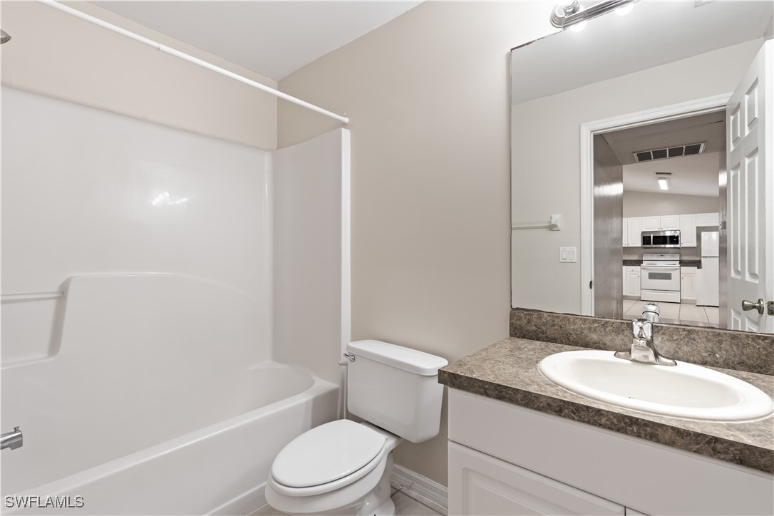 209 Meadow Road Lehigh Acres, FL 33973 - Photo 8 of 48 a bathroom with a granite countertop sink toilet and shower