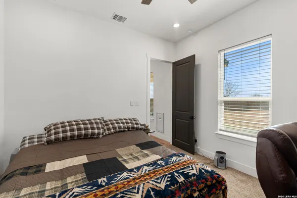 a bedroom with a bed and a window