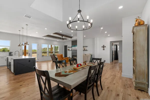 a large kitchen with a dining table and chairs