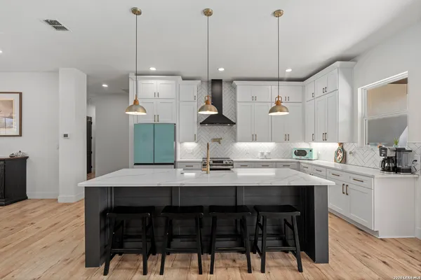 a kitchen with a table and chairs in it