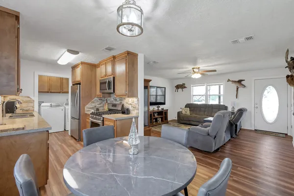 a kitchen with stainless steel appliances granite countertop a sink stove and refrigerator