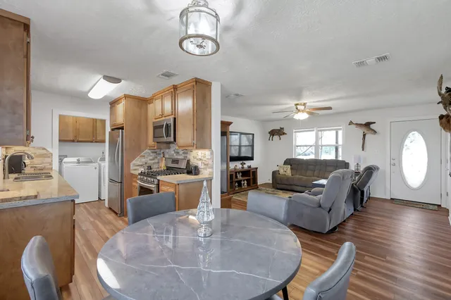 a kitchen with stainless steel appliances granite countertop a sink stove and refrigerator