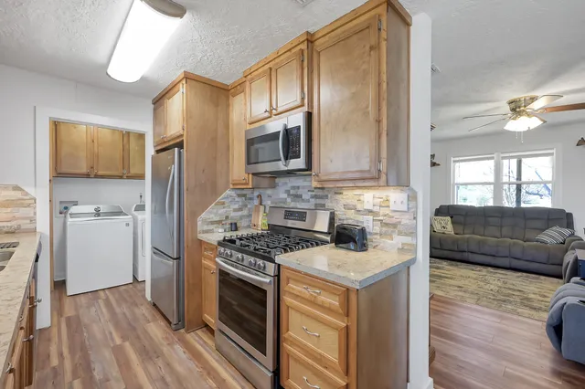 a kitchen with a sink stove and cabinets