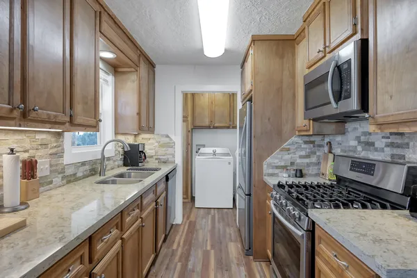 a kitchen with a sink cabinets and dining table chair