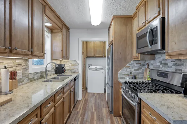 a kitchen with a sink cabinets and dining table chair