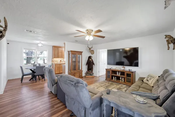 a living room with furniture a flat screen tv and a fireplace